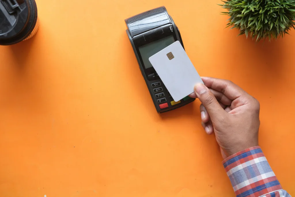 Image of a customer tapping their credit card to make a purchase